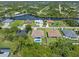 Aerial view showcases a backyard pool surrounded by greenery in a residential area at 9151 Melody Cir, Port Charlotte, FL 33981