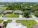 Aerial view of the property in a residential area, showcasing the neighborhood's layout and landscaping at 9151 Melody Cir, Port Charlotte, FL 33981