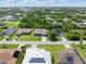 Aerial view showcases homes with lush landscaping, solar panels and spacious driveways at 9151 Melody Cir, Port Charlotte, FL 33981