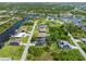 An aerial view of waterfront homes on a canal with boat docks and lush landscaping at 9151 Melody Cir, Port Charlotte, FL 33981