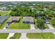 Aerial view of a residential neighborhood with nicely landscaped properties and tree-lined streets at 9151 Melody Cir, Port Charlotte, FL 33981