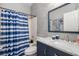 Stylish bathroom featuring blue and white tiled walls, modern fixtures, and a shower-tub combo at 9151 Melody Cir, Port Charlotte, FL 33981