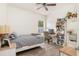 Bright bedroom featuring a ceiling fan, decorative pillows, and plenty of natural light at 9151 Melody Cir, Port Charlotte, FL 33981