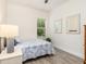 Bright bedroom featuring white walls, light gray flooring, and plenty of natural light at 9151 Melody Cir, Port Charlotte, FL 33981