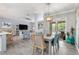 Bright dining area with wood floors, modern decor, and natural light, perfect for Gathering gatherings at 9151 Melody Cir, Port Charlotte, FL 33981