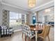 The dining room features a round wood table and view to the living room and front yard at 9151 Melody Cir, Port Charlotte, FL 33981