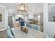 Charming dining area with modern lighting, wood floors, and a view into the kitchen at 9151 Melody Cir, Port Charlotte, FL 33981
