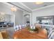 This dining room features a round wood table and view to the living room and front yard at 9151 Melody Cir, Port Charlotte, FL 33981