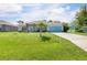 Charming single-story home with a well-manicured lawn and inviting blue accents at 9151 Melody Cir, Port Charlotte, FL 33981