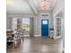 Bright foyer with a blue front door, wood-look floors, and elegant decor at 9151 Melody Cir, Port Charlotte, FL 33981