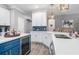 Bright kitchen with white cabinets, blue accents, quartz countertops, and modern appliances at 9151 Melody Cir, Port Charlotte, FL 33981