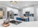 Spacious kitchen with stainless steel appliances, white cabinets, blue island, and quartz countertops at 9151 Melody Cir, Port Charlotte, FL 33981