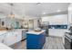 Contemporary kitchen featuring a blue island, stainless steel appliances, and sleek countertops at 9151 Melody Cir, Port Charlotte, FL 33981
