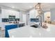 Beautiful kitchen with white cabinets, a blue island, stainless steel appliances, and a modern backsplash at 9151 Melody Cir, Port Charlotte, FL 33981