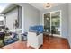 Screened-in lanai with comfortable seating, a view of the pool, and wood-look flooring at 9151 Melody Cir, Port Charlotte, FL 33981