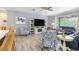 Spacious living room showcasing stylish furnishings, wood-look floors, and a cozy atmosphere at 9151 Melody Cir, Port Charlotte, FL 33981