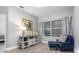 Comfortable sitting area with a blue chair, display cabinet, and neutral decor at 9151 Melody Cir, Port Charlotte, FL 33981