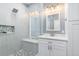 The bath has a glass shower stall with mosaic floor, single vanity and medicine cabinet at 9151 Melody Cir, Port Charlotte, FL 33981
