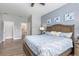 This bedroom features a decorative wood-look wall, light-colored wood floor, and ensuite bathroom at 9151 Melody Cir, Port Charlotte, FL 33981