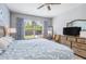 The main bedroom has light-colored wood-look floors, a decorative headboard and a large sunny window at 9151 Melody Cir, Port Charlotte, FL 33981