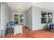 Comfortable covered patio with ceiling fan, wood-look flooring, and sliding glass doors to the home interior at 9151 Melody Cir, Port Charlotte, FL 33981