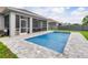 Sparkling pool with a screened patio, complemented by a well-manicured lawn and inviting ambiance at 9151 Melody Cir, Port Charlotte, FL 33981