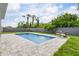 Refreshing backyard pool with paved surround, complemented by a privacy fence at 9151 Melody Cir, Port Charlotte, FL 33981