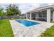 Beautiful pool with modern pavers, screened patio area, and well-maintained lawn at 9151 Melody Cir, Port Charlotte, FL 33981