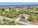 Aerial view showcasing the home's location in a residential neighborhood with lush greenery and water features at 9213 Spring Cir, Port Charlotte, FL 33981
