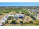 Aerial view of property featuring ample parking, exterior building, and lush landscape at 9213 Spring Cir, Port Charlotte, FL 33981