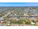 Aerial view of a waterfront community showcases houses nestled among canals and lush landscapes, with scenic waterways at 9213 Spring Cir, Port Charlotte, FL 33981