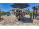 Entertain in style on this paved patio featuring an umbrella covered table and a cozy seating area at 9213 Spring Cir, Port Charlotte, FL 33981