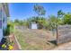 Spacious backyard with lush greenery and a storage shed, perfect for outdoor activities at 9213 Spring Cir, Port Charlotte, FL 33981