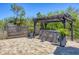 Lovely backyard retreat featuring pavers, a hot tub under pergola, and privacy fence at 9213 Spring Cir, Port Charlotte, FL 33981