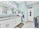 Bright bathroom with granite countertop, dual sinks, and white cabinets at 9213 Spring Cir, Port Charlotte, FL 33981