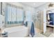 Bright bathroom featuring a soaking tub and glass walk-in shower at 9213 Spring Cir, Port Charlotte, FL 33981