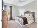 Cozy bedroom with plush carpeting, ceiling fan, and view of nature at 9213 Spring Cir, Port Charlotte, FL 33981