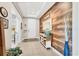 Inviting entryway featuring tile flooring, a tray ceiling, and a stylish accent wall at 9213 Spring Cir, Port Charlotte, FL 33981