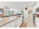 Bright kitchen featuring granite countertops, white cabinetry, and stainless steel appliances at 9213 Spring Cir, Port Charlotte, FL 33981