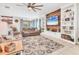 Cozy living room featuring a comfortable sofa, built-in shelving, and a large flat-screen TV at 9213 Spring Cir, Port Charlotte, FL 33981