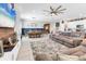 Comfortable living room offers a wall entertainment center, dining area and access to the kitchen at 9213 Spring Cir, Port Charlotte, FL 33981