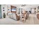 Open-concept living room boasts a wall entertainment center with shelving and a ceiling fan at 9213 Spring Cir, Port Charlotte, FL 33981