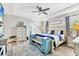 Bright primary bedroom featuring a tray ceiling, ensuite bathroom, and plentiful natural light at 9213 Spring Cir, Port Charlotte, FL 33981