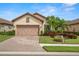 One-story home with tile roof and landscaped front yard at 10441 Highland Park Pl, Palmetto, FL 34221