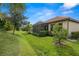 Beautiful home exterior with tile roof and a lush backyard at 10441 Highland Park Pl, Palmetto, FL 34221