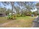 Landscaped backyard with lush greenery and mature trees at 12511 Walton Ave, New Port Richey, FL 34654