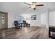 Bright living room with hardwood floors, ceiling fan, and comfy armchairs at 12511 Walton Ave, New Port Richey, FL 34654