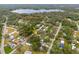 Aerial view showing home's location in a residential neighborhood near a lake at 12511 Walton Ave, New Port Richey, FL 34654