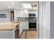 White cabinets, granite counters, and stainless steel appliances in this updated kitchen at 103 1St E St # 204, St Petersburg, FL 33715