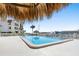 Refreshing community pool with a thatched-roof cabana at 103 1St E St # 204, St Petersburg, FL 33715